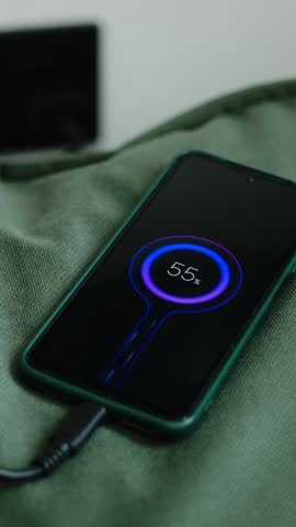 Vertical video. Smart phone charging battery at home