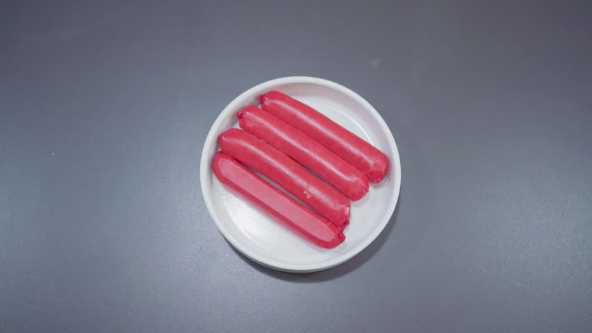 Red hot dogs are an emulsified sausage typically made from a blend of finely ground pork, beef, and sometimes