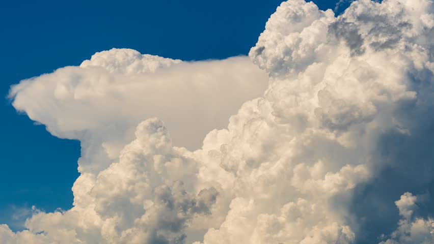 Epic cloud formations shift across the sky with a time lapse feel, revealing dynamic weather building through layered motion, evolving textures, dramatic light changes, and growing atmospheric intensity