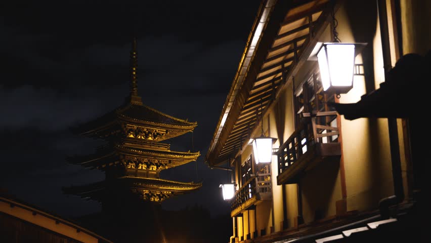 View of Gion district street, Kyoto, Higashiyama-ku, Japan, night illumination of Ninnenzaka and Sannenzaka streets, with old wooden tea houses, Hokanji temple and Yasaka Pagoda, Gion geisha quarter