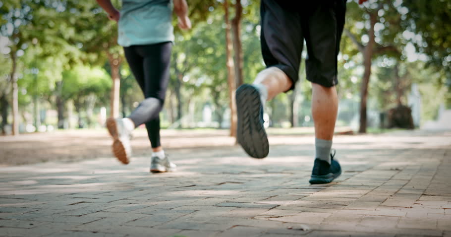 People, legs or running club in park with fitness, sports challenge or endurance training for wellness. Group, feet or shoes outdoor with cardio workout, speed exercise or Paris marathon preparation.