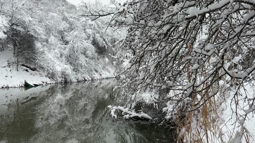 Soldier Lake in the winter season. The branches of the trees are covered with a large layer of snow. Weather, forecast.