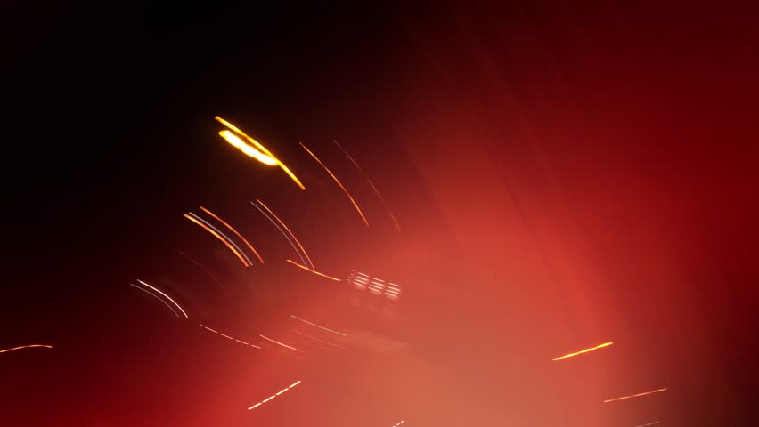 Abstract night light background with motion blur, colorful reflections, and soft glow creating a cinematic urban atmosphere. Long exposure.