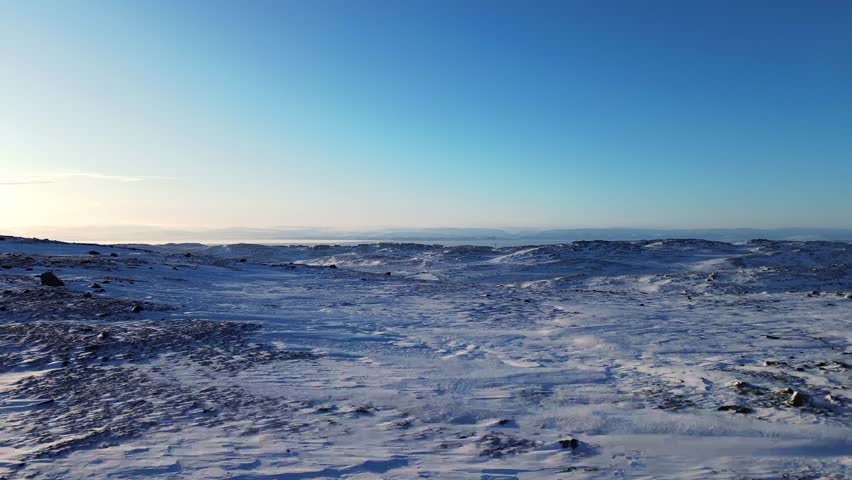 Slow drone push over expansive Arctic tundra landscape outside Iqaluit in Nunavut, Canada.