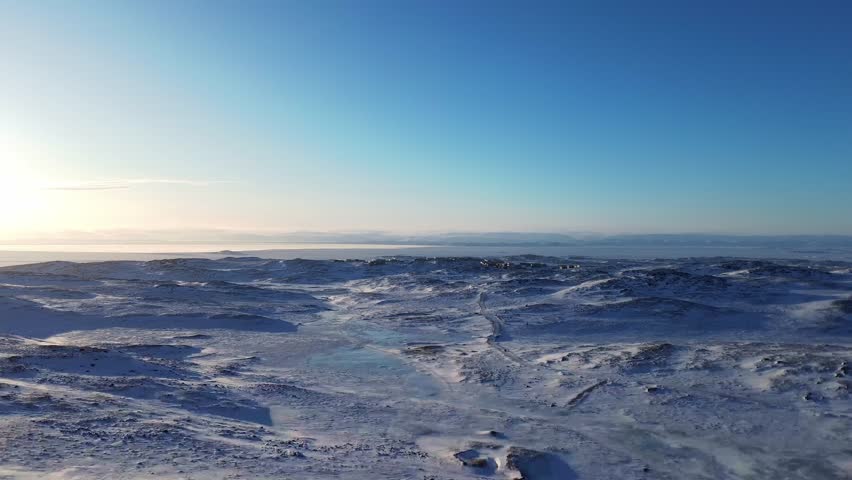 Drone pulls back over Arctic tundra revealing the remote northern city of Iqaluit, Nunavut.