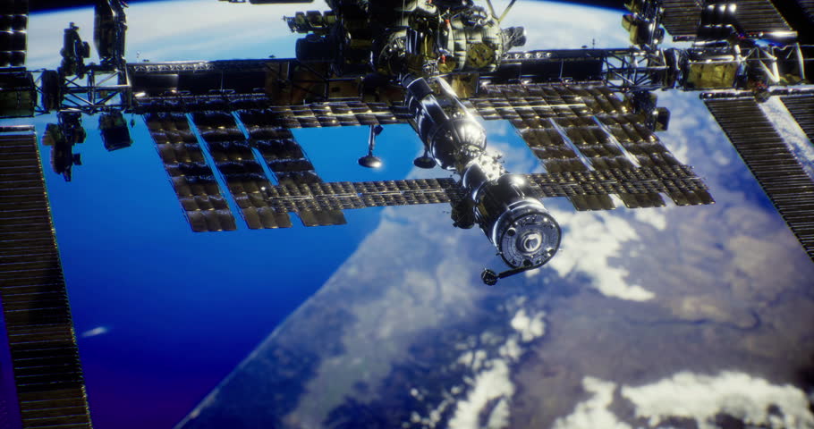 The International Space Station floats above Earth, showcasing a vibrant blue atmosphere and land below. This view highlights the engineering marvel and the beauty of our planet.