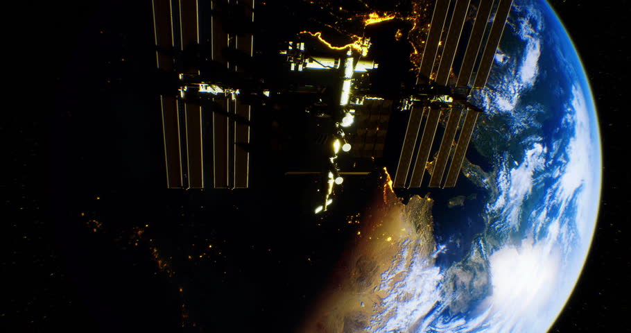The International Space Station floats above Earth, showcasing a breathtaking view of city lights at night. The curvature of the planet is visible, highlighting its beauty from space.