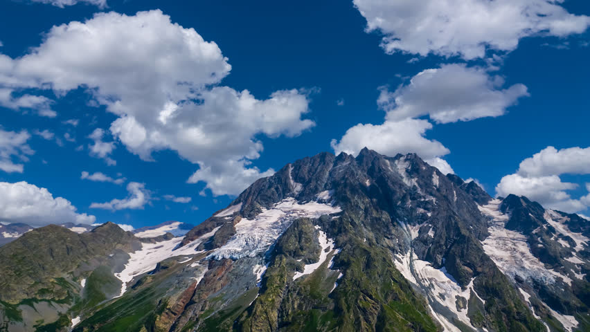 mount top in a snow and ice at the bright day time lapse scene