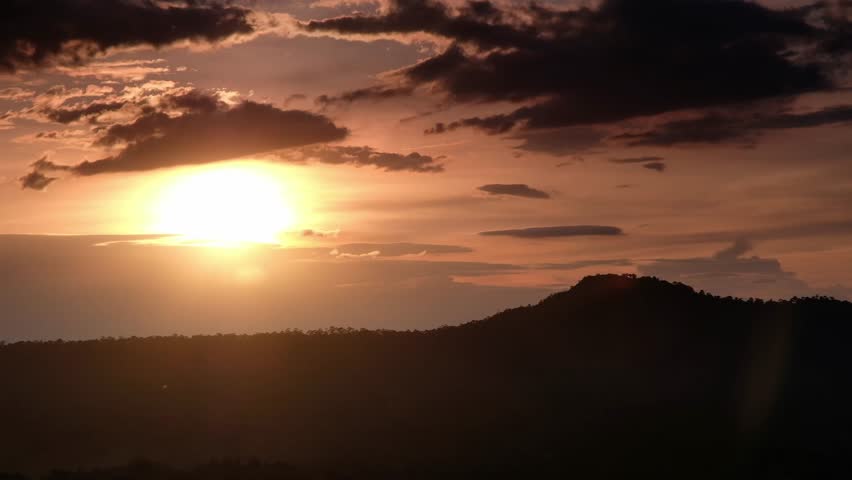 orange twilight sunset sky over green  mountains scene