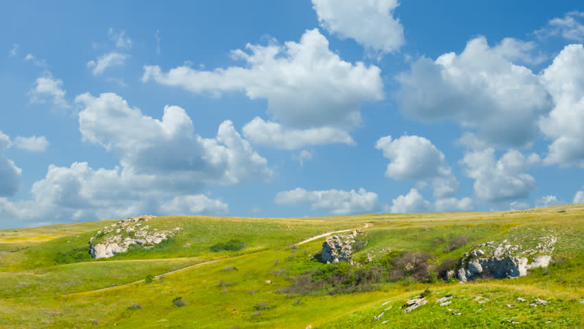 green hills under a dense cloudy sky time lapse scene