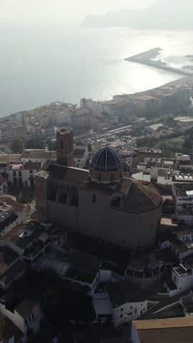 Vertical panoramic aerial view capturing Altea’s old town along the Mediterranean coast with the iconic church rising above the historic rooftops.