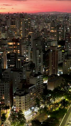 Sunset at Sao Paulo Brazil. Cityscape of sunset sky at city Sao Paulo Brazil. Scenic landscape of colorful sky and illuminated towers offices buildings and skyscrapers. Urban life scenery.