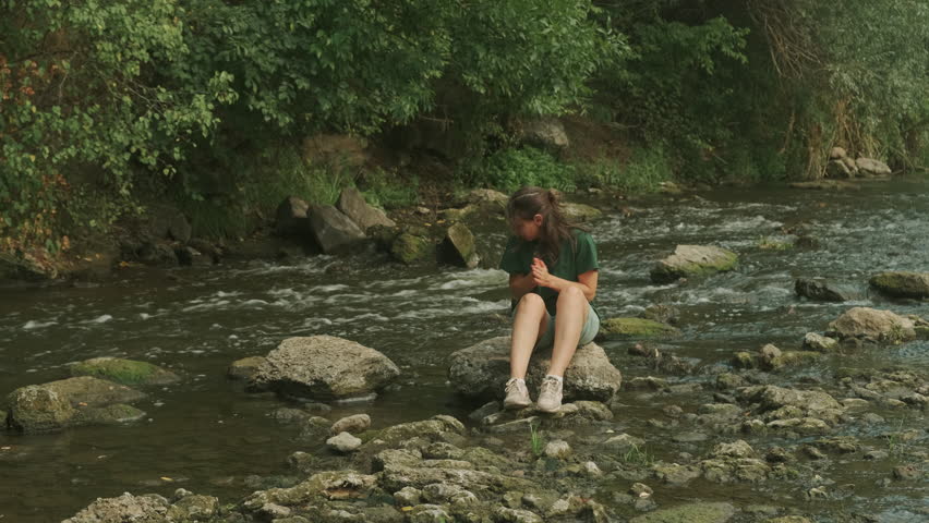 Embarking on a Youthful Exploration by the Serene Riverbank, Embracing Natures Beauty