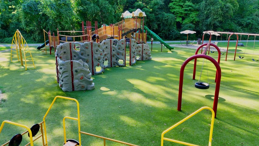 Colorful playground with climbing walls and swings at Prairie Creek Park, Brownstown