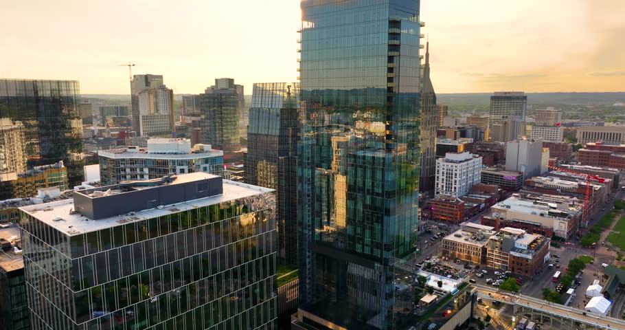 Nashville downtown office district in Tennessee, USA lit by bright evening sun. High commercial and residential skyscraper buildings in modern American city.