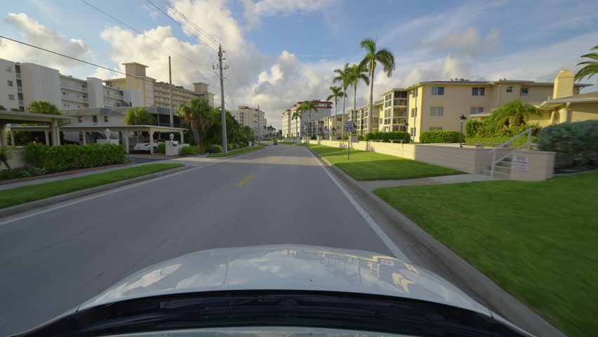 Point of view car driving in Venice city. American streets with Florida tourist infrastructure. Transportation concept.