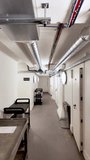 Industrial Basement Corridor With Exposed Ductwork White Walls and Utility Carts Ideal For Office Storage or Underground Facility Concepts and Designs - Powered by Shutterstock - Get 15% off with code: PIKWIZARD15