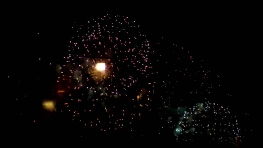 Shimmering colorful fireworks bursting in the night sky in celebration