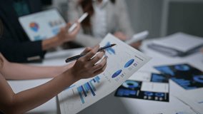 Close-up of colleagues discussing business analytics and financial reports in the office - Powered by Shutterstock - Get 15% off with code: PIKWIZARD15