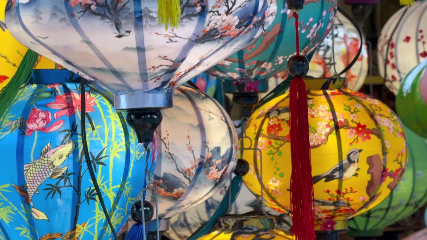 Colorful traditional lanterns displayed at local market in Hoi An, Vietnam. Decorative silk lanterns with detailed patterns represent Asian culture, craftsmanship, and everyday life in Southeast Asia.