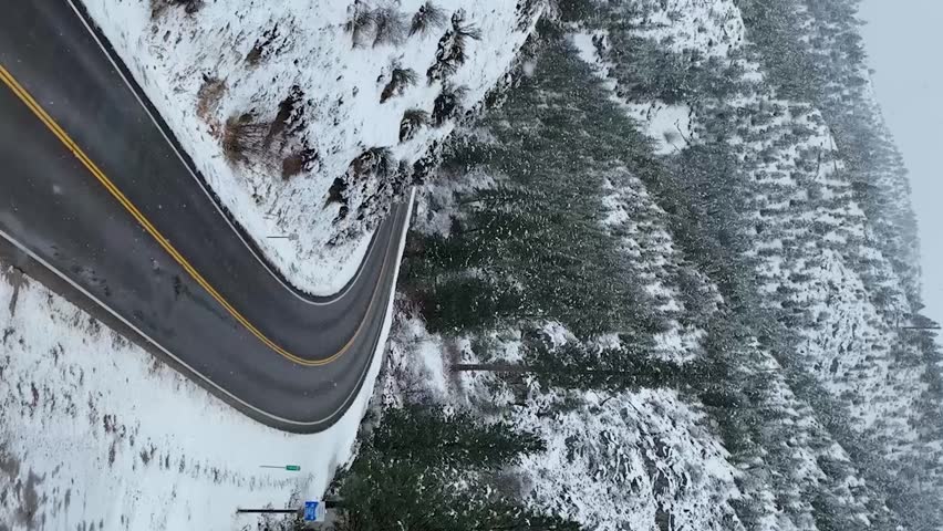 Vertical aerial view of mountain road in Idaho during winter