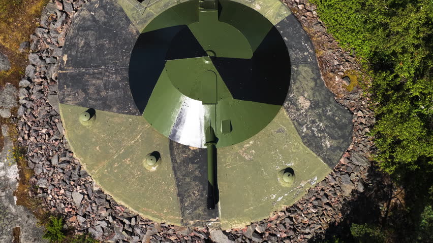 Aerial view tilting away from a old canon in the Nordic Archipelago, summer day