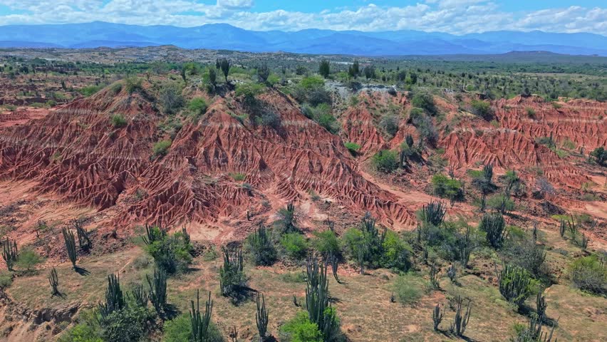 Epic Travel drone footage highlighting the uniqueness of Famous tourist destination, Red desert in Tatacoa Colombia. A geological marvel with stunning erosion patterns that shape the raw landscape.