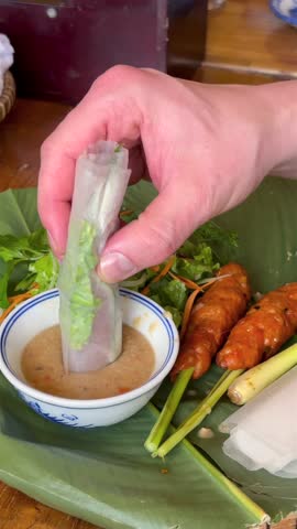 Grilled chopped pork served with rice paper, fresh vegetables, and dipping sauce, capturing authentic Vietnamese food culture, daily life, and traditional local dining.