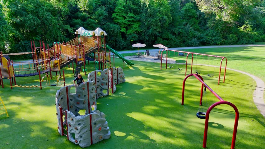 Kid playing at Prairie Creek Park playground in Brownstown, Michigan, USA