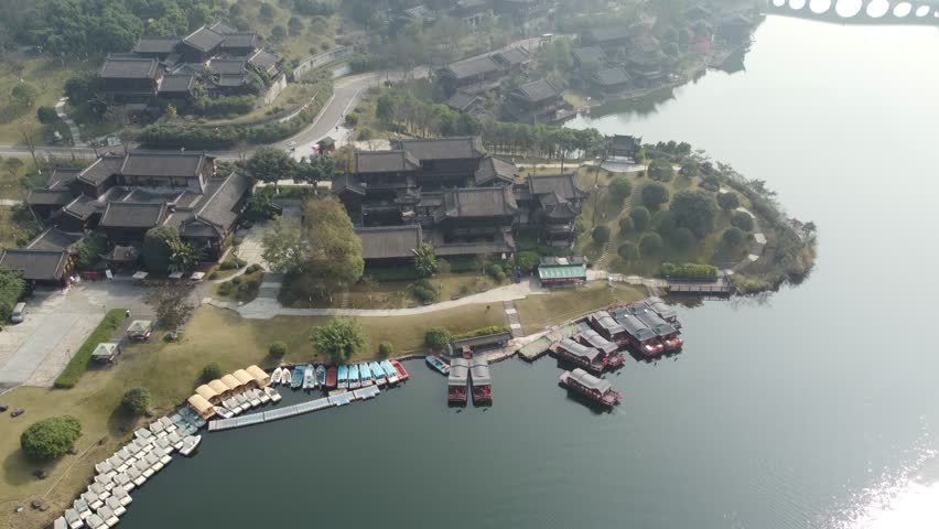 Aerial view of the Garden Expo Park with a large peaceful lake and traditional Chinese pavilions. Scenic public park and cultural landscape in Chongqing, China.