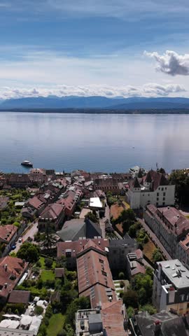 Aerial view Nyon town Switzerland shores of Lake Geneva Lac Léman Alps background