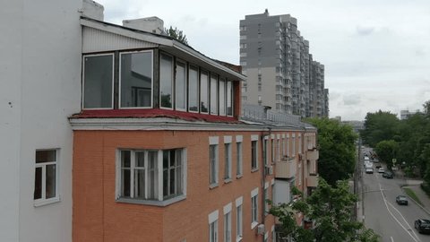 Drone Descending beside Urban Residential Building