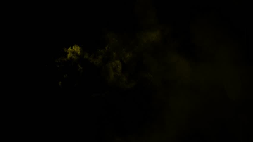 Small wisps of golden yellow smoke drift from left to right. Isolated on black background, ideal for compositing