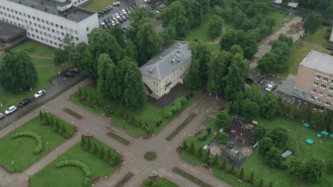 Drone Descending over Park toward Residential Building