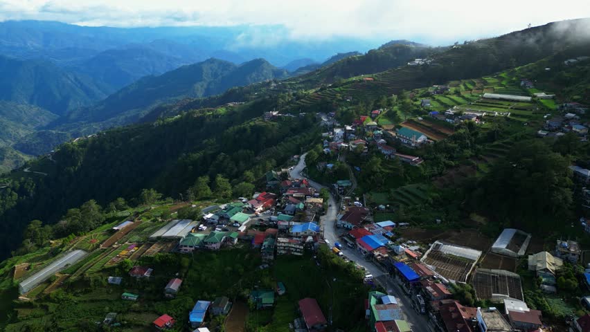 Top down aerial view of Atok Benguet Philippines showing zigzag highway patterns and organized vegetable fields