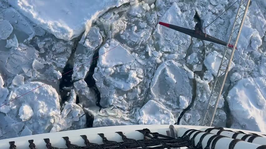 Expedition Ship Navigating Through Dense Antarctic Sea Ice