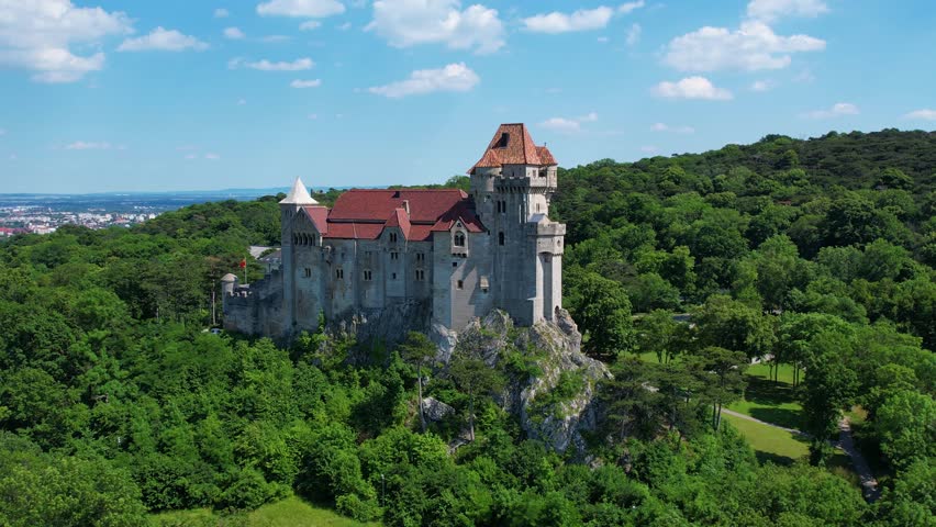 Explore the aerial view of Burg Liechtenstein in Austria, highlighting its impressive architecture and lush green surroundings. Discover the beauty of this historic site.