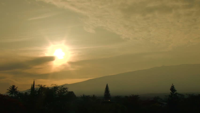 Time lapse of bright sun shining through morning haze in Maui, Hawaii.