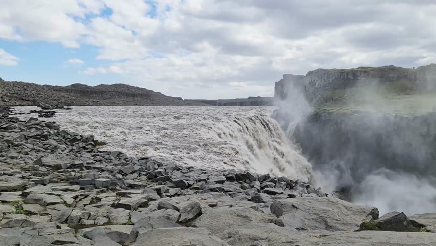 Gullfoss waterfall, a famous Icelandic landmark, flows powerfully through a rugged canyon