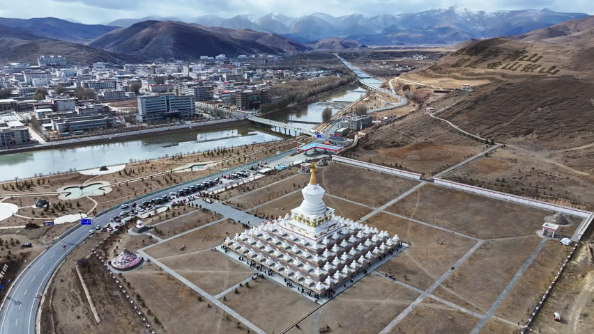 Daocheng, Garzê Tibetan Autonomous Prefecture, China - 25th November 2025 - The White Pagoda of Daocheng County under sunshine