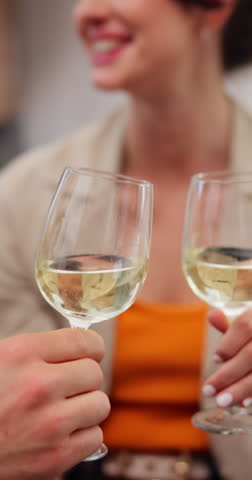 Couple, cheers and hands with wine, new home and celebration for investment property and achievement. Happy, woman and toast with partner for loan success, moving and people with alcohol in house