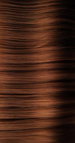 Ultra slow motion shot of dark brown hair flowing in smooth, elegant waves, forming natural curves and motion. Captured at 1000 fps, revealing fine texture, shine, and fluid cinematic movement.