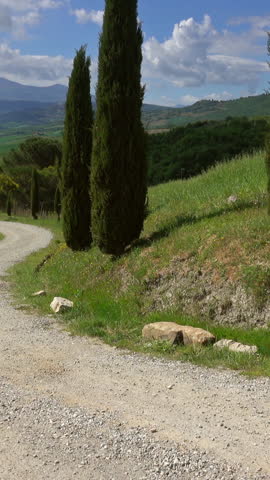 Tuscany landscape with farmhouse and cypresses at sunny day. Province of Siena, Italy. Vertical video