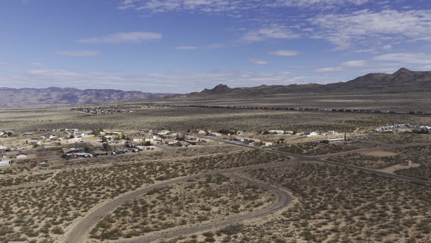 Aerial of Valle Vista Community in Kingman Arizona with train and mountains
