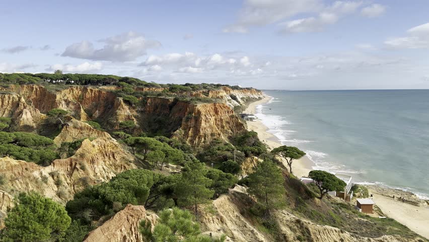 View of the sea and rocks of the beach of Olhos de Agua, Albufeira, Algarve, Portugal.