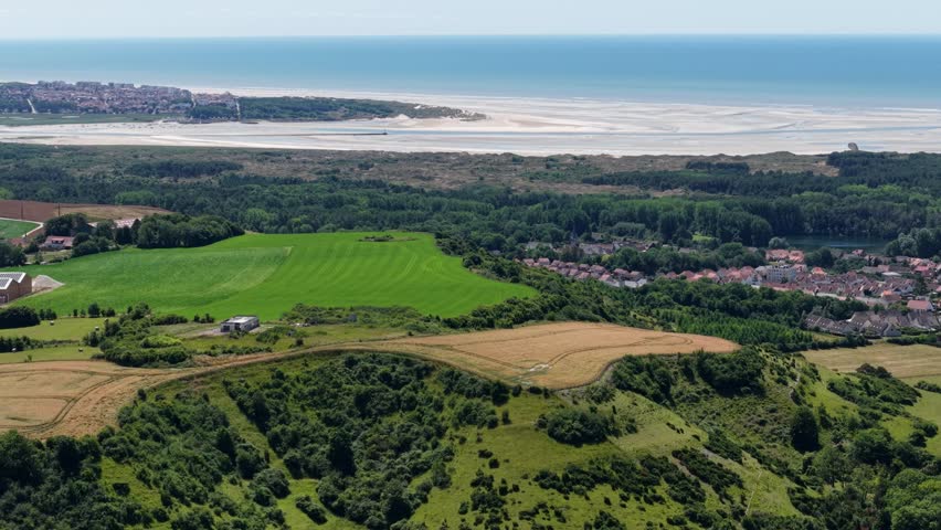 Summer aerial panorama of French coastal fields and sea