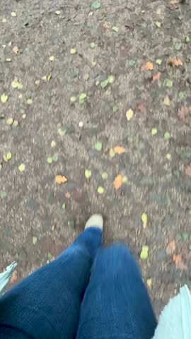Walking on Wooden Planks Near the Water With Casual Shoes on a Sunny Day