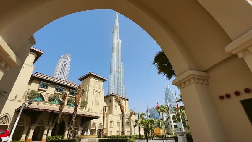Establishing shot of traditional arabian architecture framed by an elegant arch in downtown of Dubai, no logos