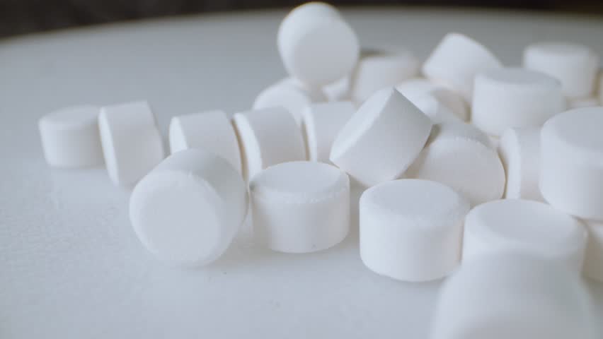 Lots of white pills on a spinning platform