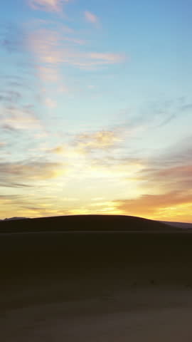 Beatiful landscape in Sahara desert at sunrise, zoom out timelapse. Vertical video